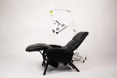Black massage chair with control panel on a white background
