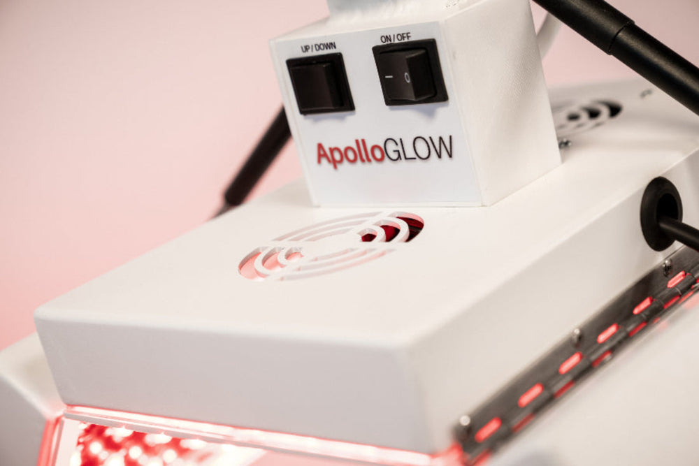 ApolloGLOW device with red light therapy on a pink background