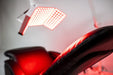 Close-up of a red LED light panel on a white background
