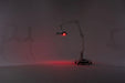 Red light lamp on a stand in a dark room