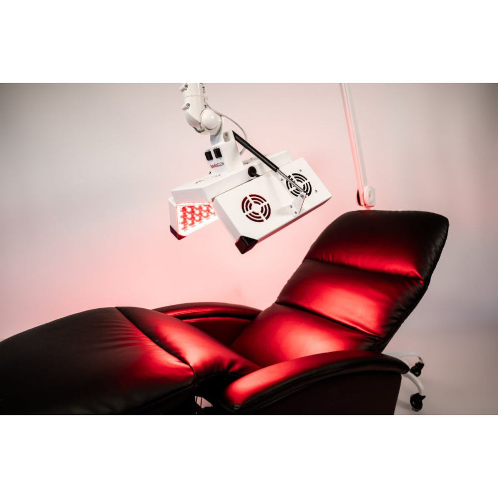 Red recliner chair with a medical device above it on a pink background