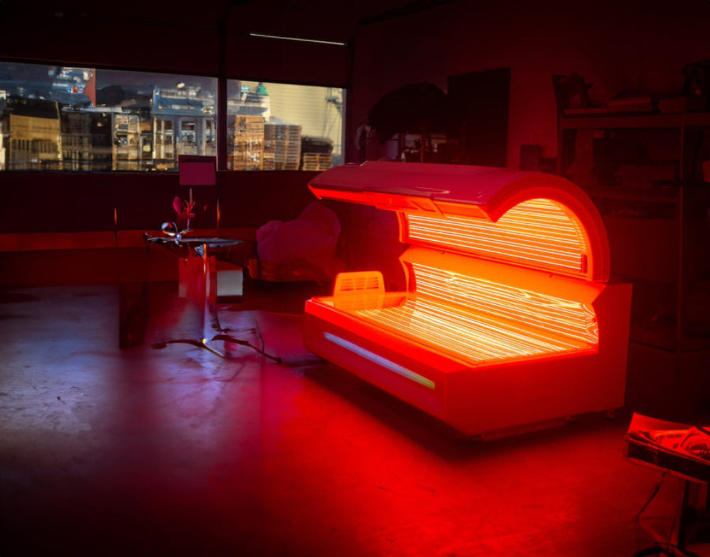 Eros Red Light Therapy bed in a dimly lit room