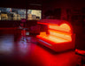 Eros Red Light Therapy bed in a dimly lit room