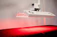 LED light therapy device on a bed with red light emission