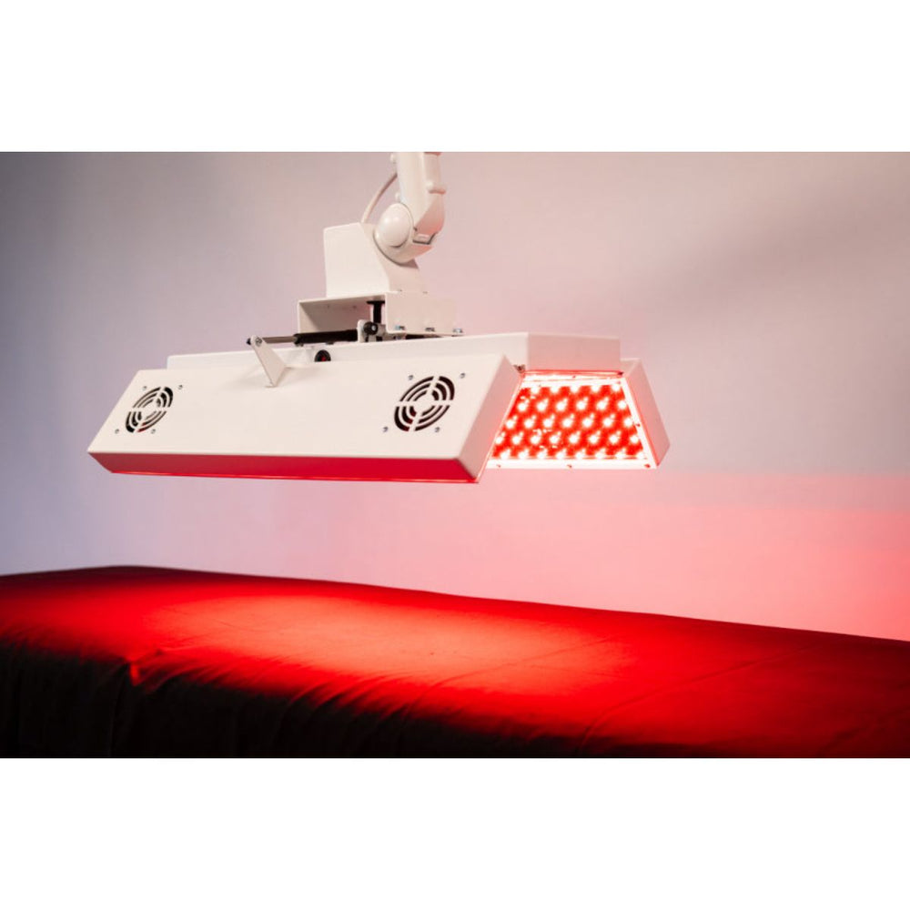 Red light therapy device emitting a red glow on a neutral background