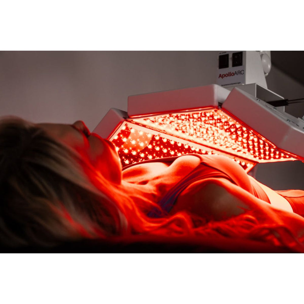 Person receiving red light therapy treatment with 'ApolloARC' equipment.