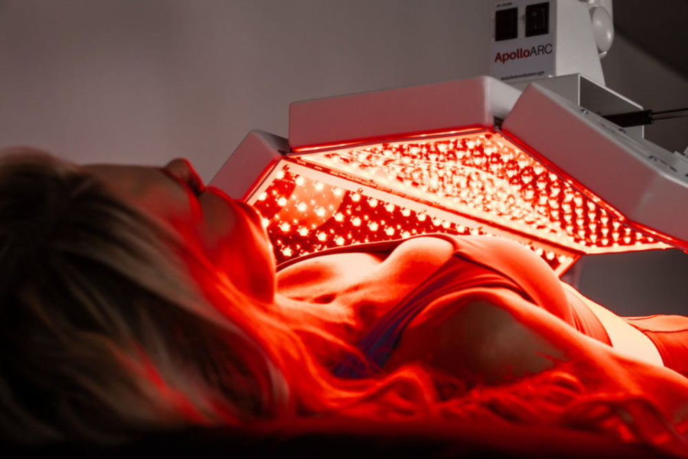 Person receiving red light therapy treatment with 'ApolloARC' equipment.