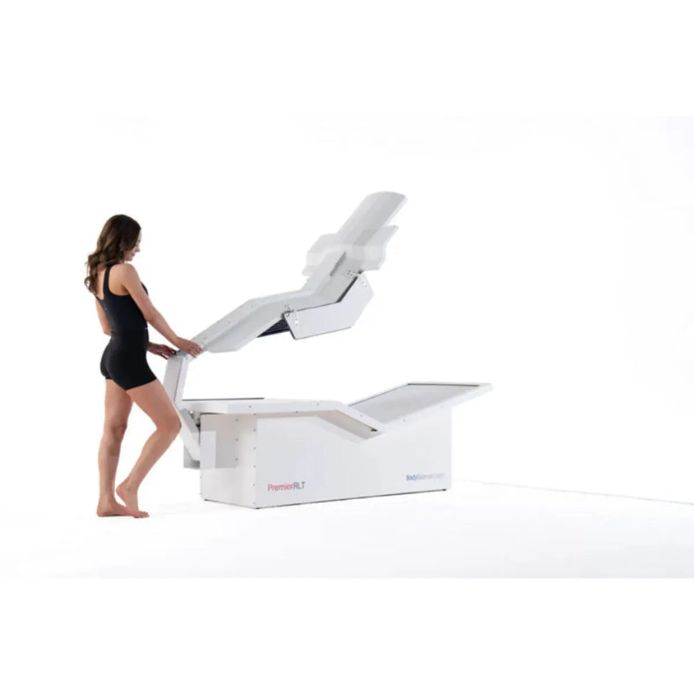 Woman using a red light therapy system on a white background