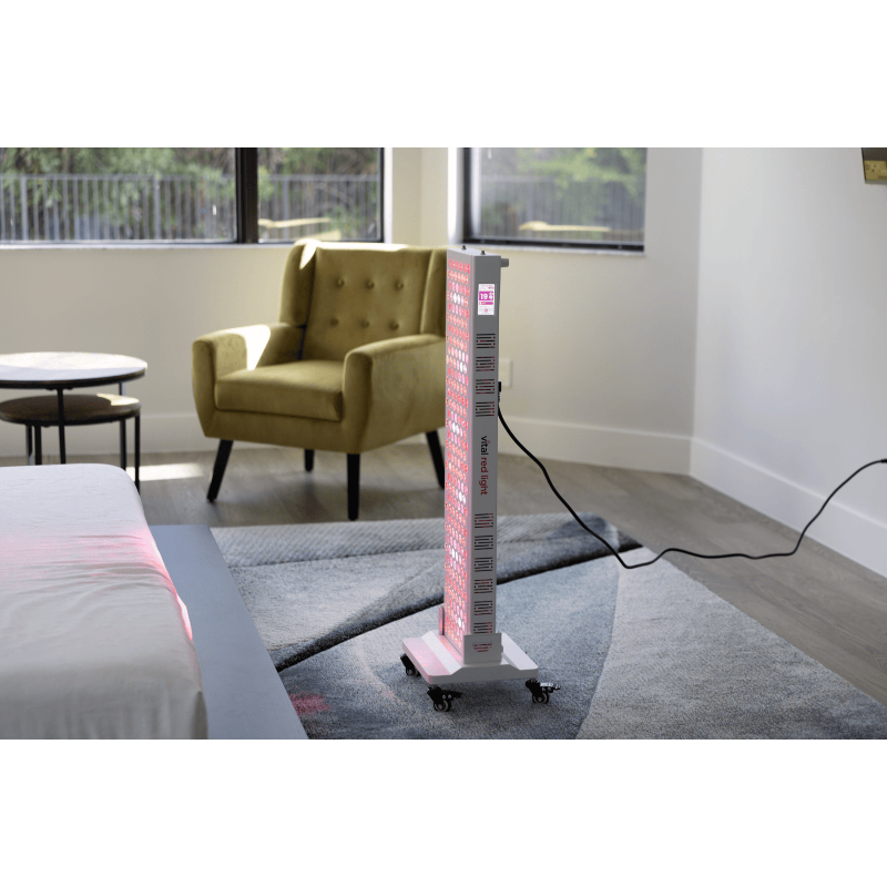 Tall rectangular object with pink and white design on a gray carpeted floor in a room with a yellow armchair and table.