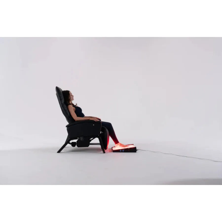 Person sitting in a futuristic chair with glowing red elements on a white background