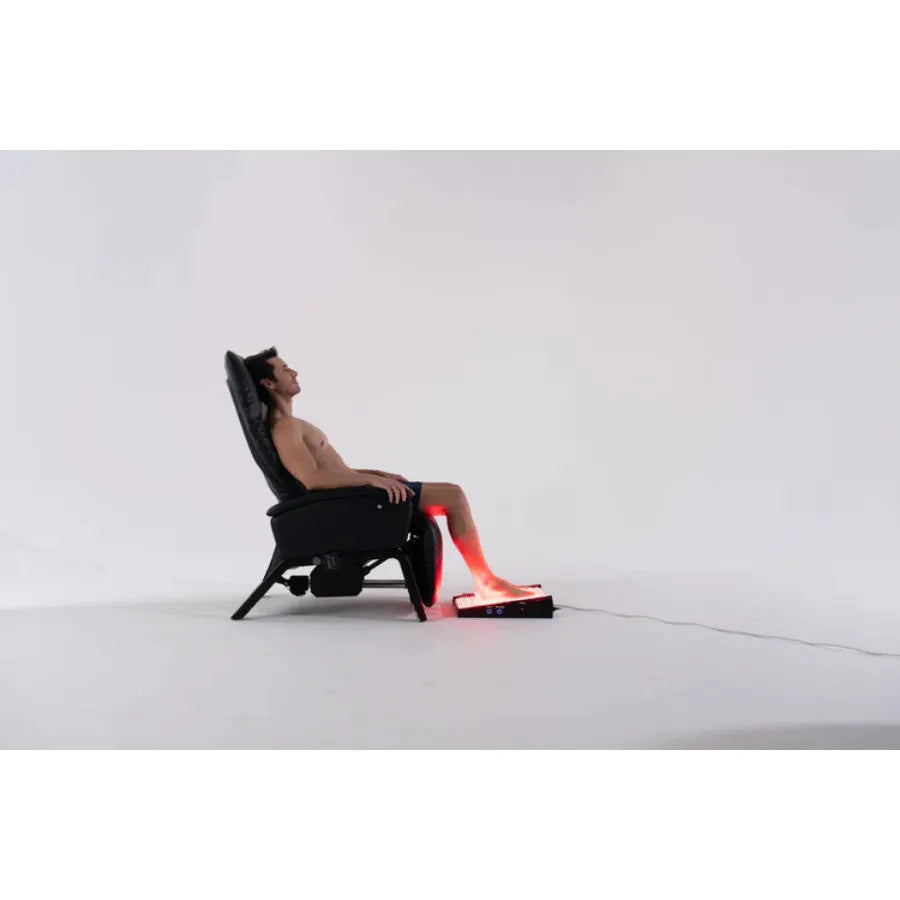Person using a massage chair with red lights on a white background