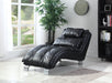 Black leather recliner chair in a room with a large window, plant, and bookshelf.