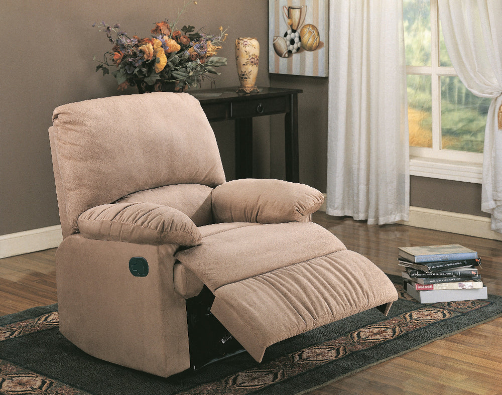 Beige recliner chair in a living room setting with a table and window in the background.