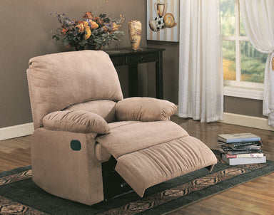 Beige recliner chair in a living room setting with a table and window in the background.