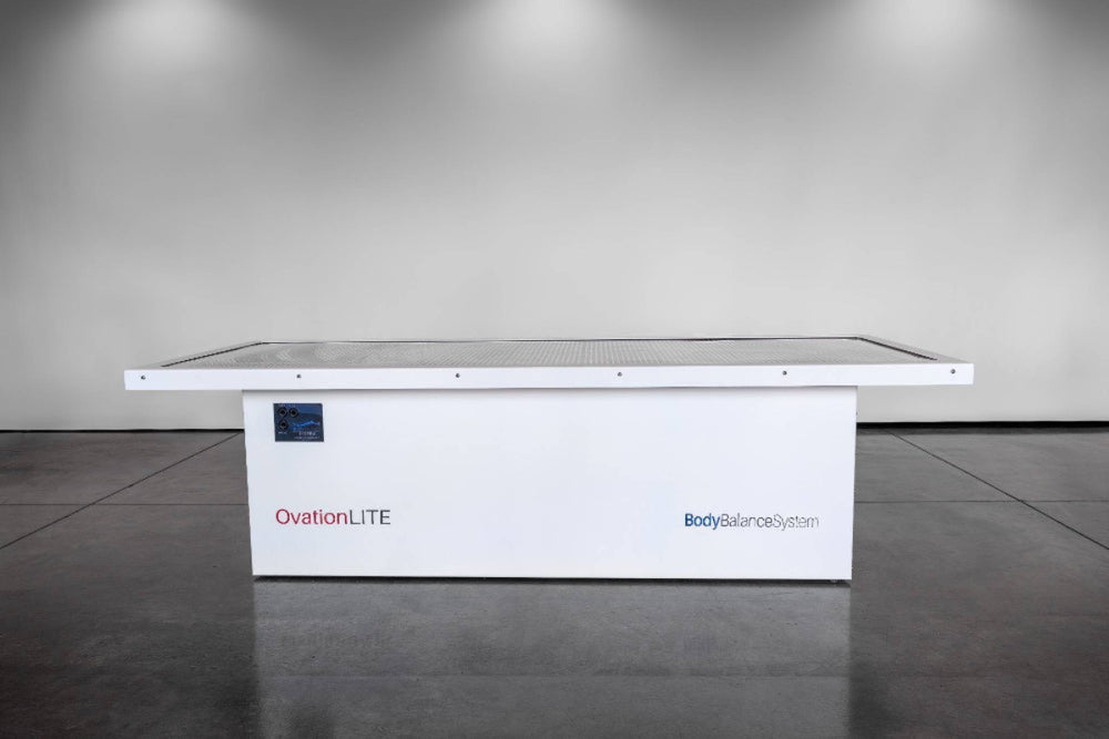 White red light table with 'OvationLITE' branding on a gray floor.
