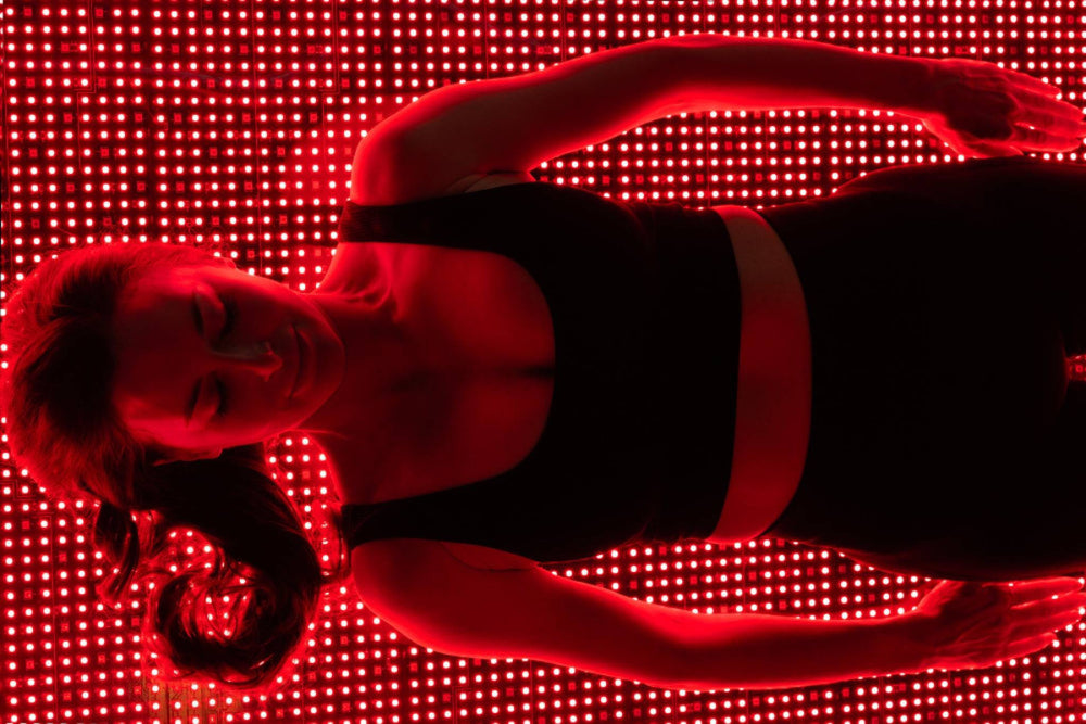 Person lying on a red LED floor with a blurred background