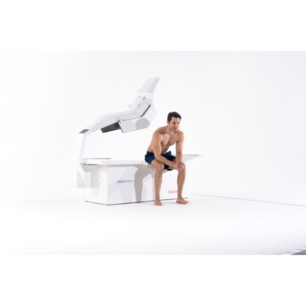 Man sitting on a futuristic white chair with a unique design on a white background