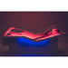 Person lying on a medical device with red and blue lighting
