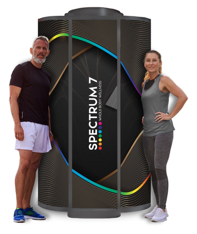 Two people standing next to a large 'Spectrum 7' product on a white background